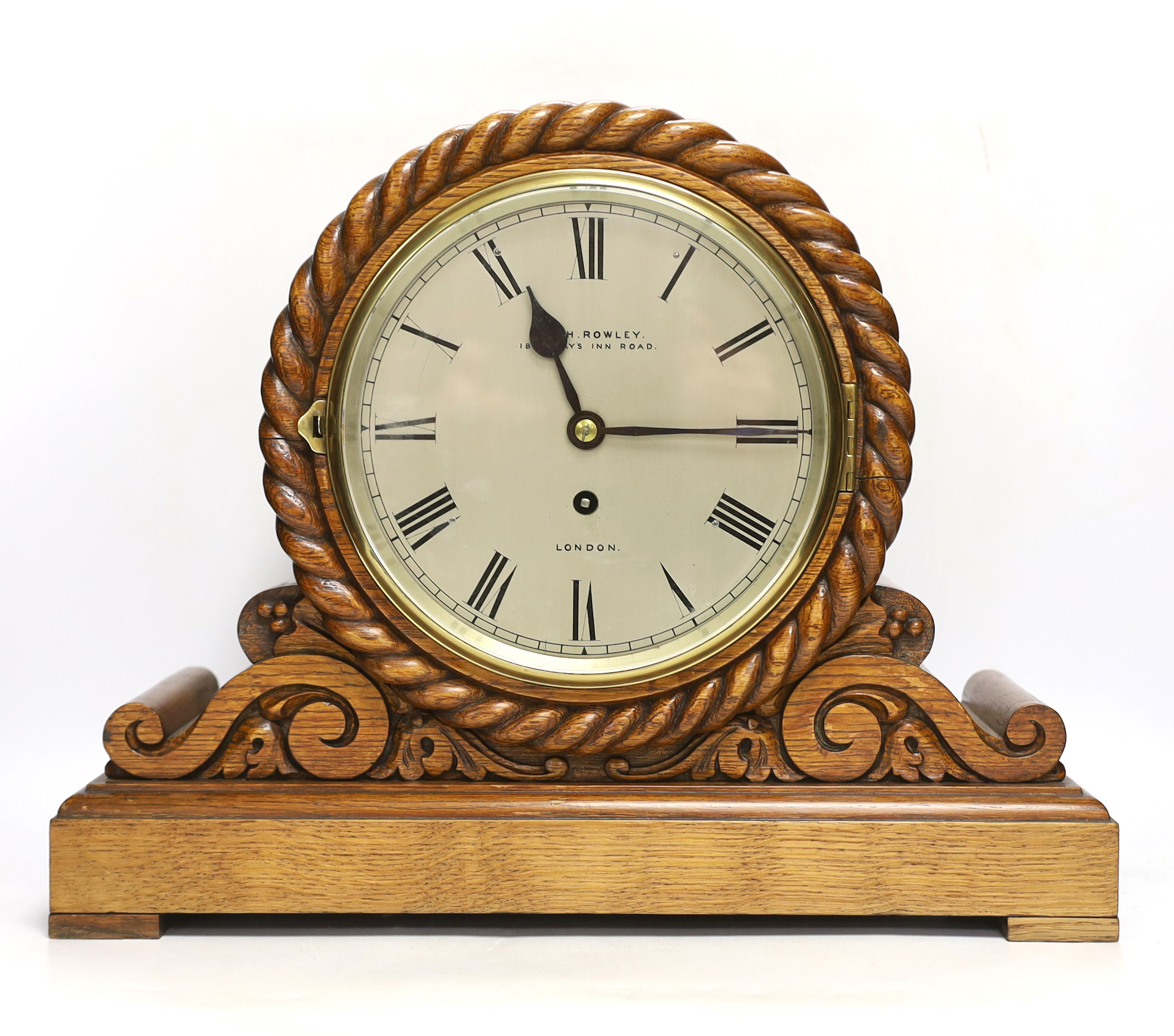 An Edwardian laminated oak single fusee mantel timepiece, A&H Rowley, 35cm high